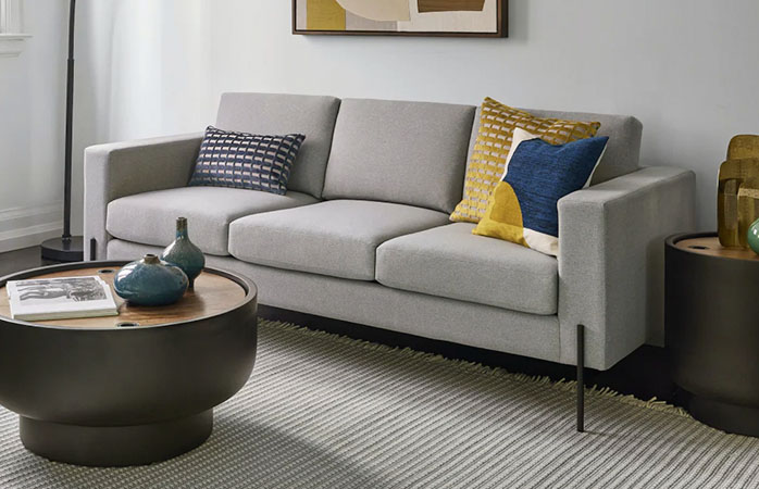 Gray Sofa with Throw pillows and round coffee table
