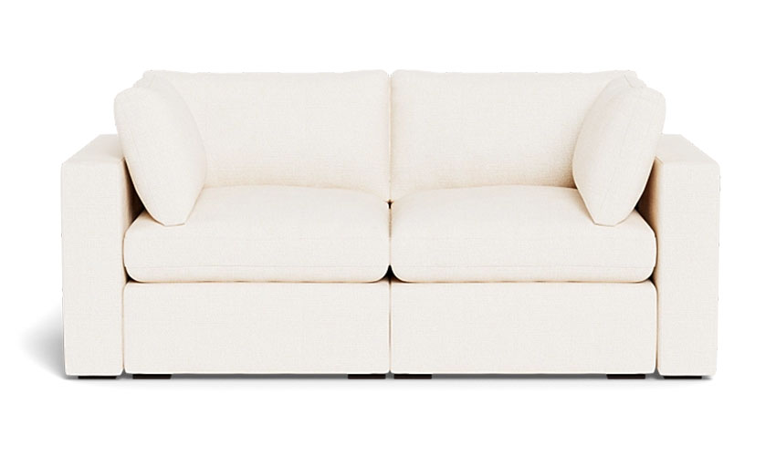 White upholstered loveseat with wooden legs