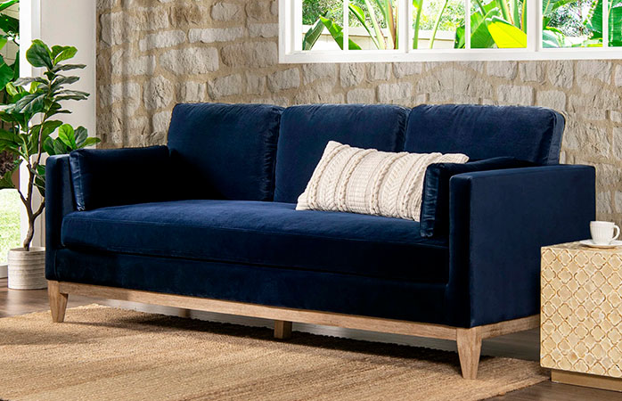 Blue Velvet Upholstered Sofa with white pillow