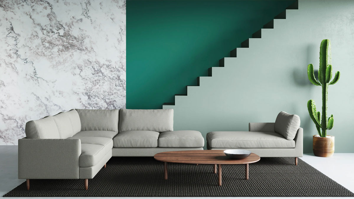L-shaped grey upholstered sofa in a very spacious places with a black rugh and round coffee table