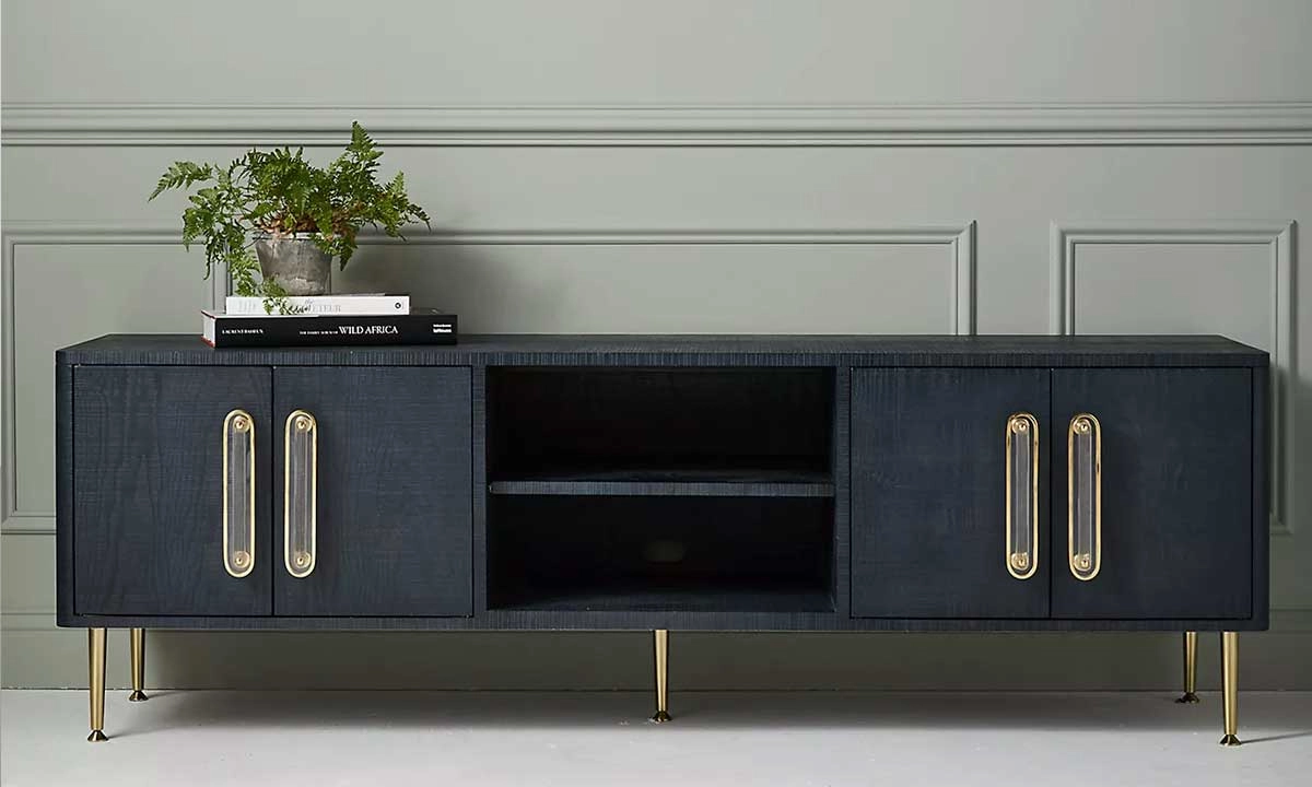 Black Media Console with golden details and legs and books in the top