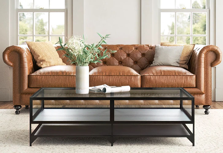 Rectangular Coffee Table with iron metal frame and glass top with books and a glass shelf