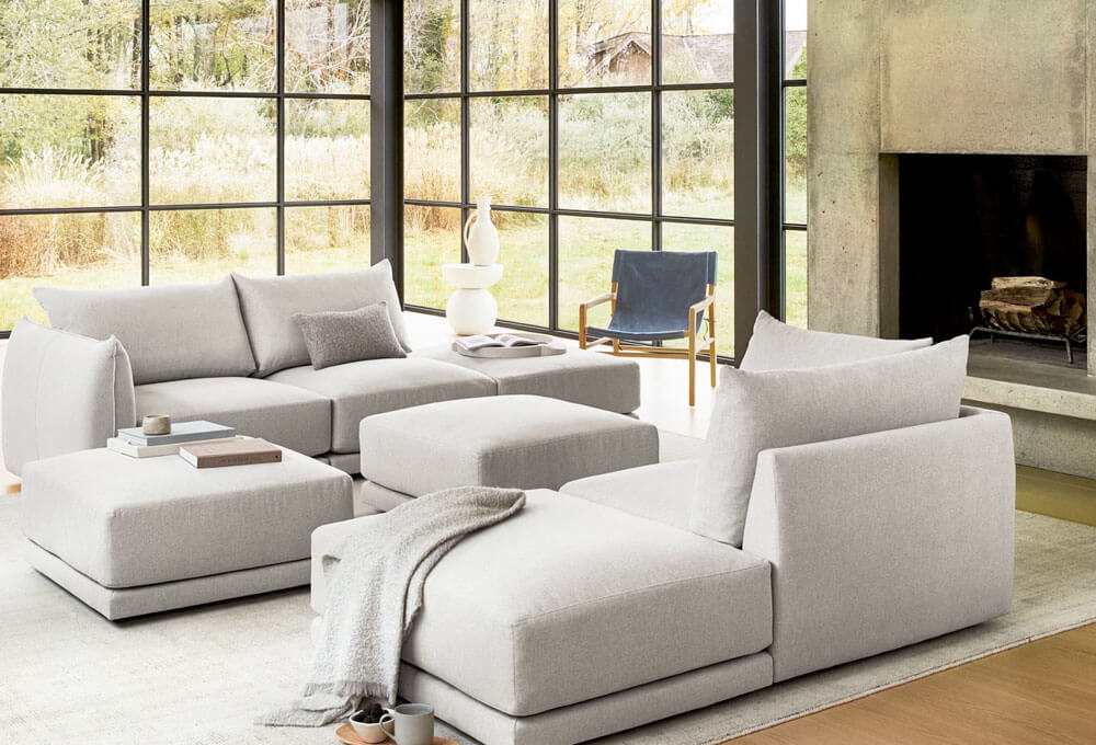 Living room with two light grey upholstered sofa and two ottoman coffee table