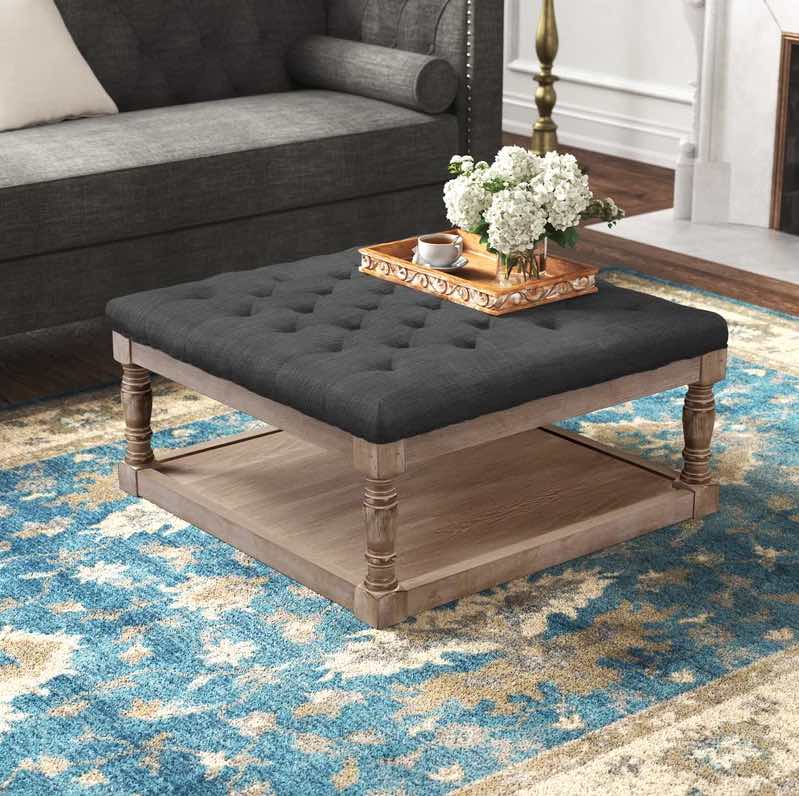 Tufted Upholstered Storage Ottoman on a bohemian rug near a dark grey sofa