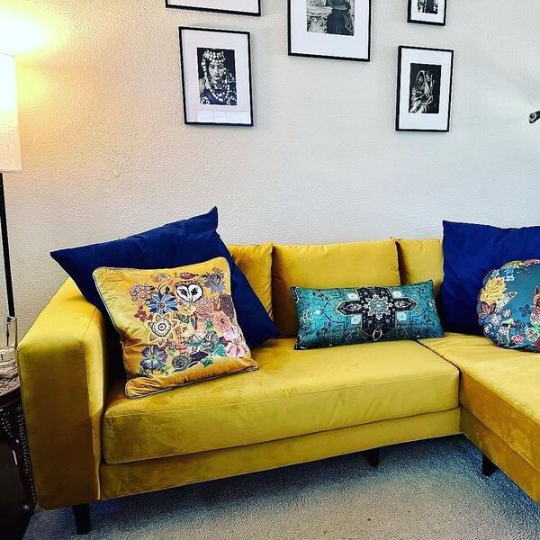 Light gray L-sectional sofa with wooden legs.