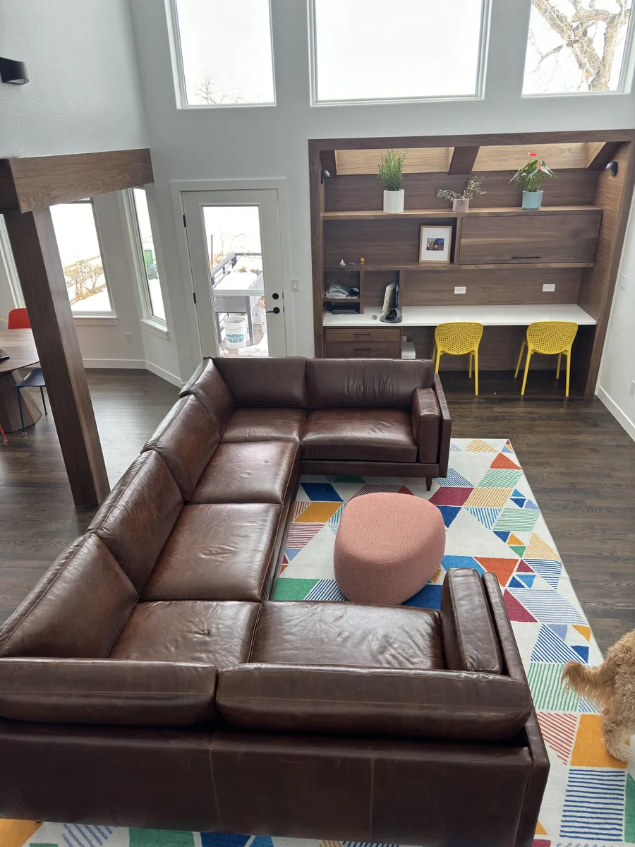 Grey sofa with wooden legs.