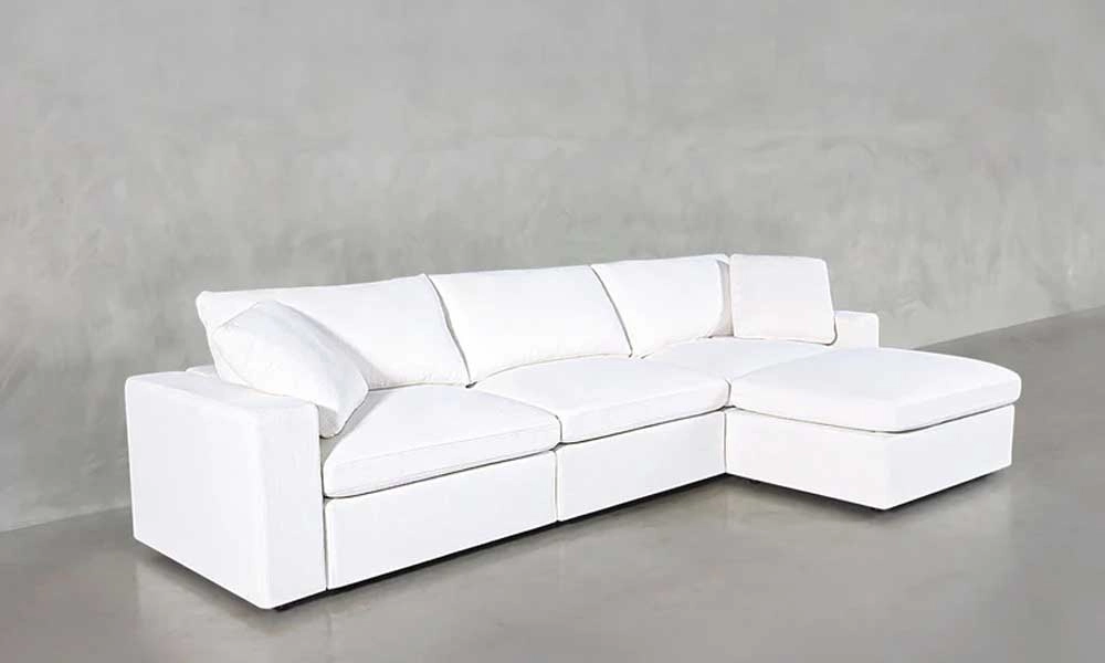 L-Shaped White Sofa with two white throw pillows
