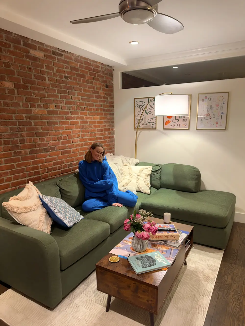 Sam sitting on the BenchMade Modern Archie Sectional in her living room