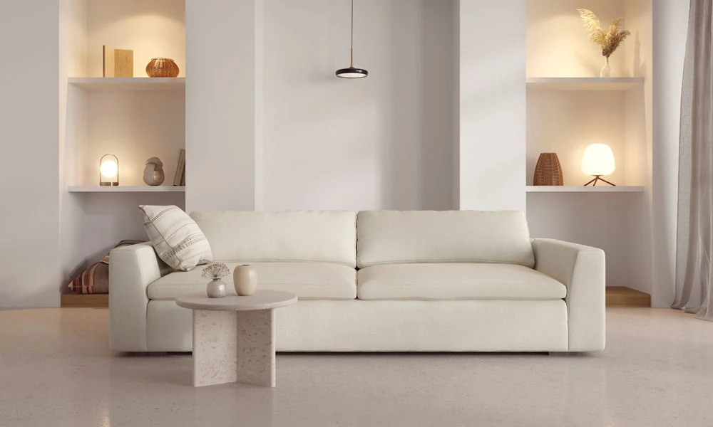 White modern modular sofa in a minimalistic living room with a rounded coffee table
