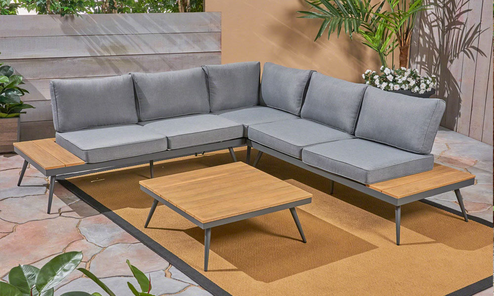 Modern 4 Piece Sectional Seating set with grey cushions in a patio near plants