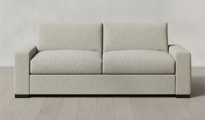 two seater white upholstered sofa in a beige room