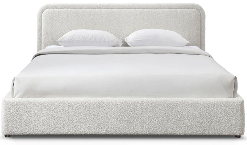 Upholstered bed frame with a round corners headboard and a mattress with white sheets 