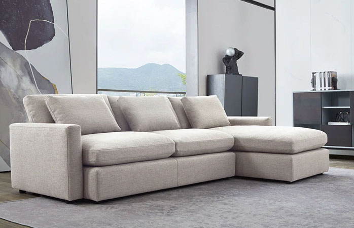 Gray upholstered sectional sofa with wooden legs