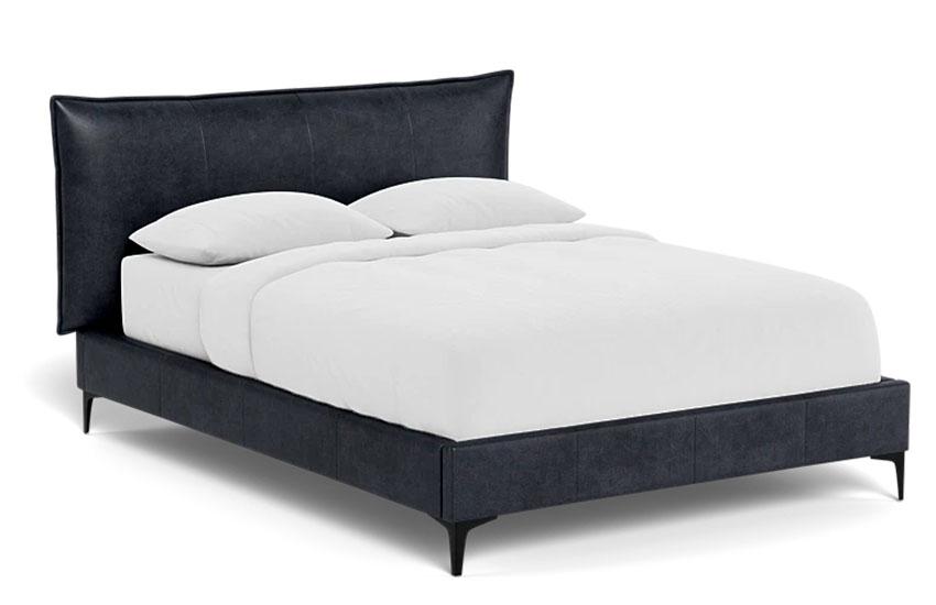 Leather upholstered bed frame with a heahboard and a mattress with white sheets