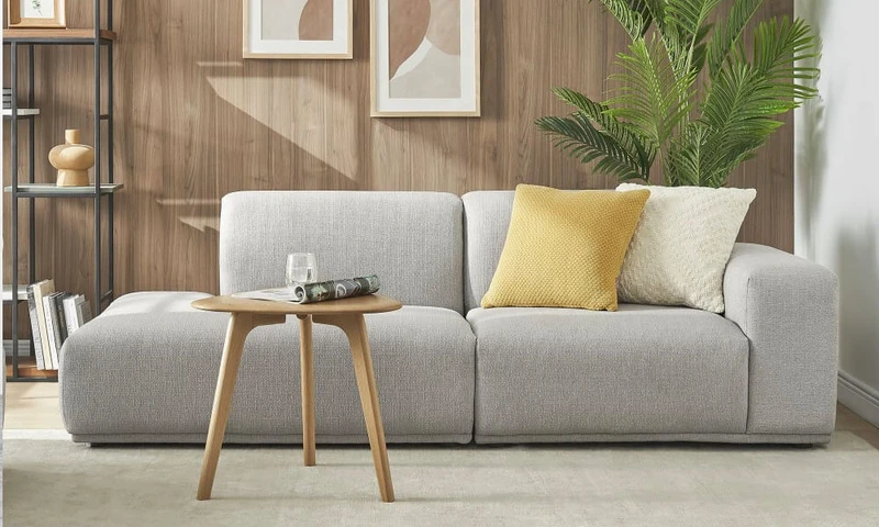 Contemporary design side chaise sofa in light grey upholstery and a modern wooden coffee table i