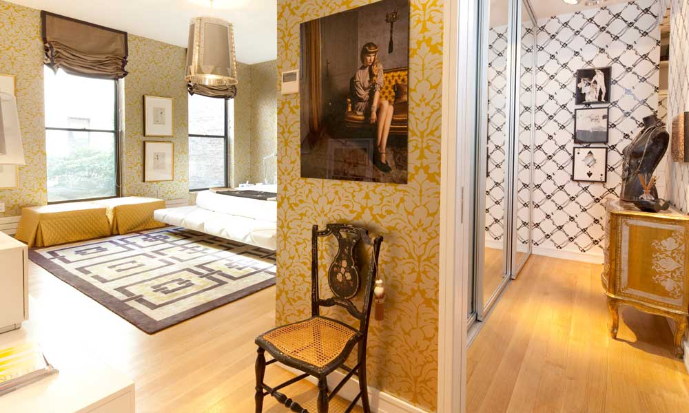 a room adorned with yellow wallpaper, complemented by wooden coffee table and a chair