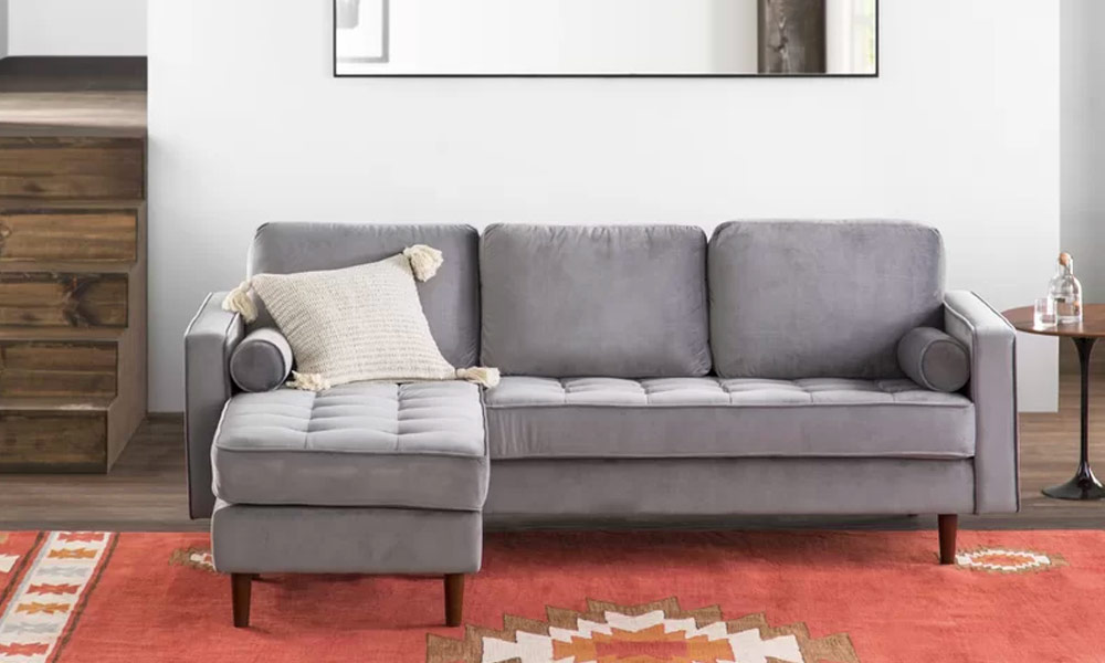 2 piece grey upholstered sectional sofa in a living room with a red rug