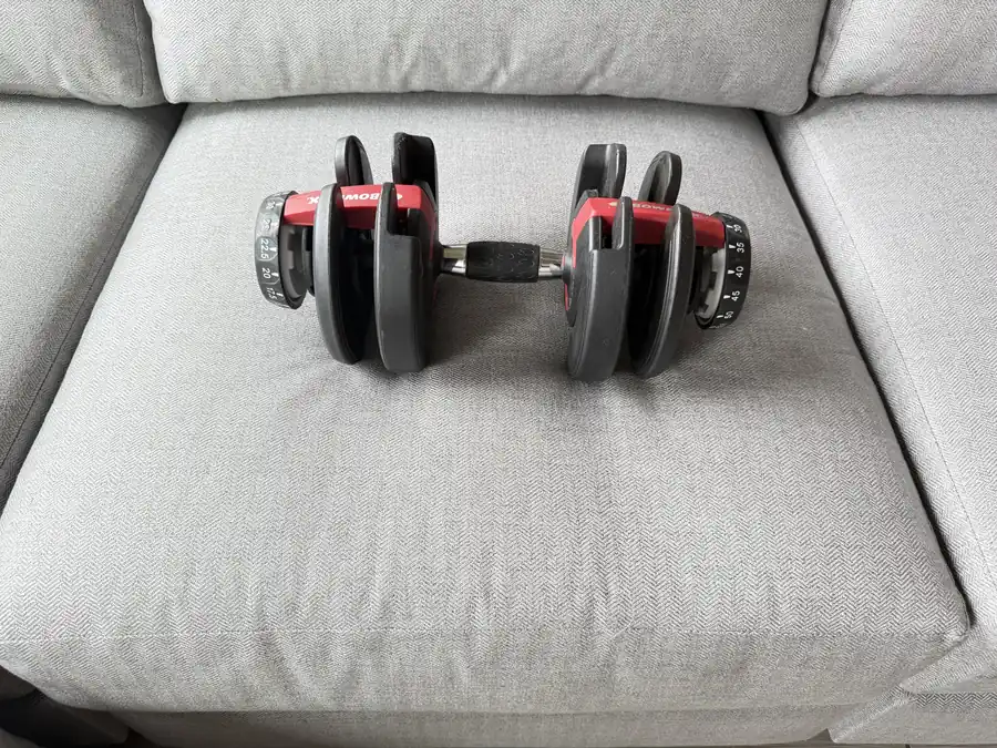 A 30-pound adjustable dumbbell resting on the Landon's seat cushion, leaving barely a dent