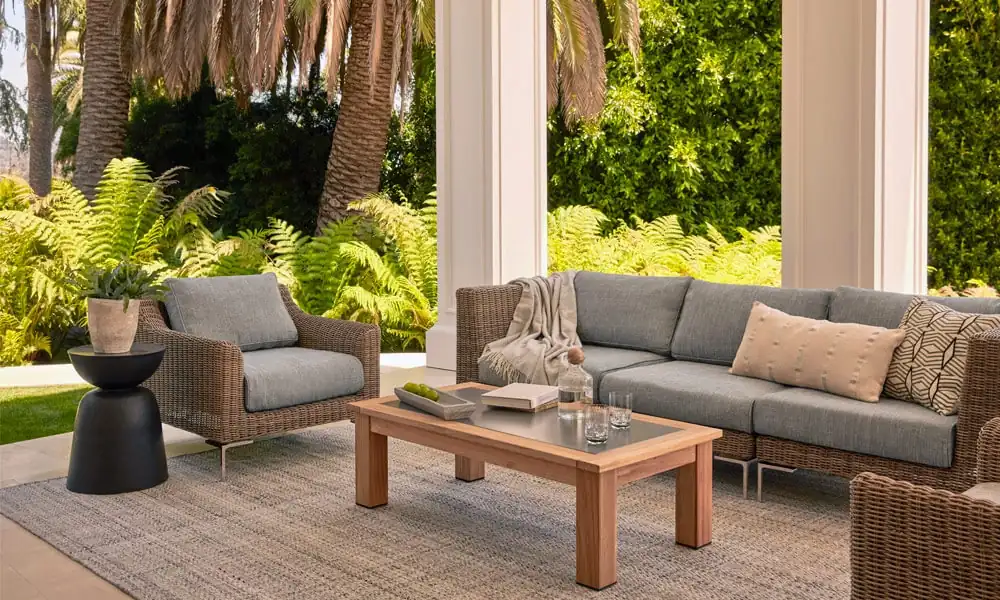 Outdoor patio with wicker furniture and palm trees