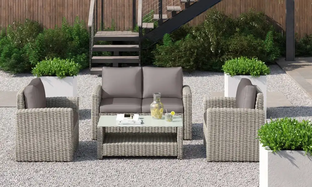 Light grey wicker seating with a light wray wicker coffee table in an outdoor space