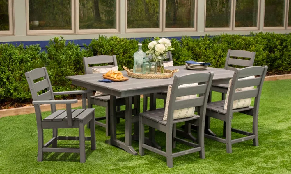 7-Piece gray Farmhouse Dining Set in a garden with food in the table