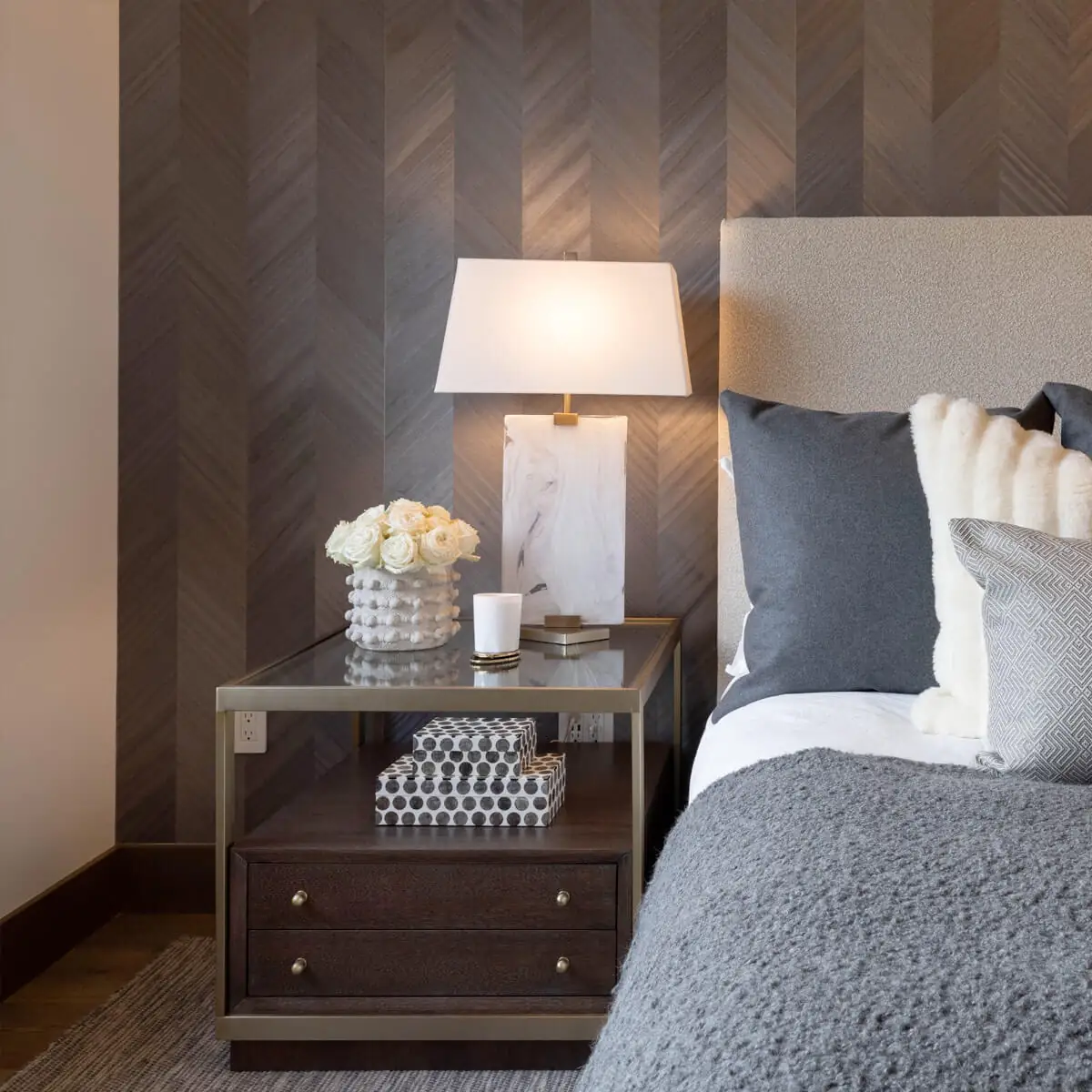 Modern nightstand with two drawers and a storage space, and flowers and a lamp in the top