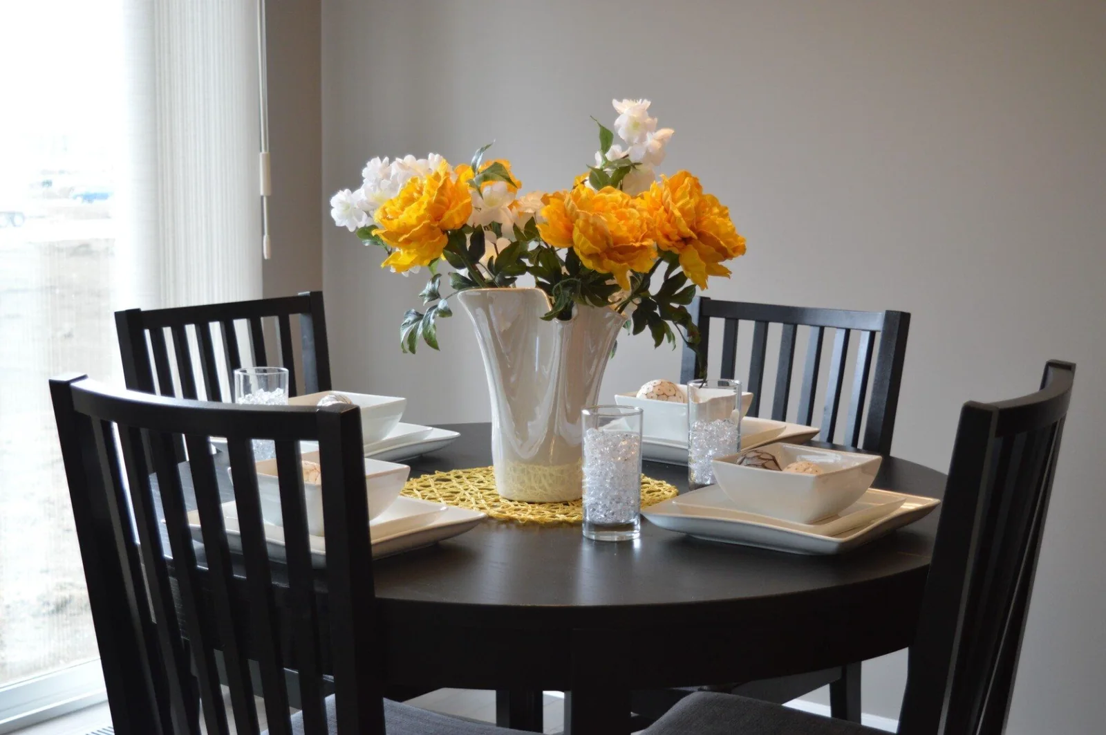 round table with flowers and white tableware