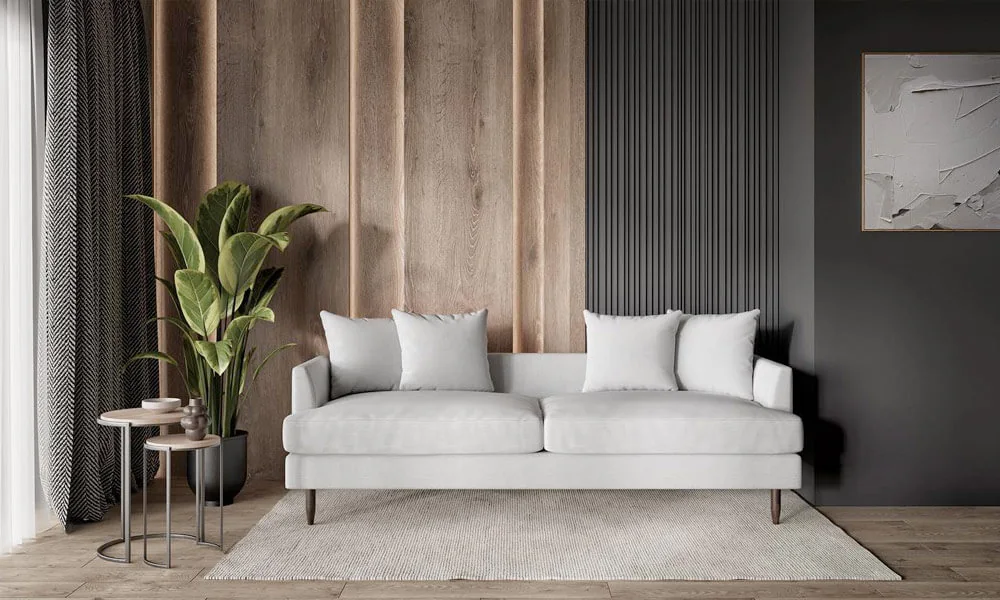 white upholstered sofa with dark legs in a living space with a white rug, plants and sidetables