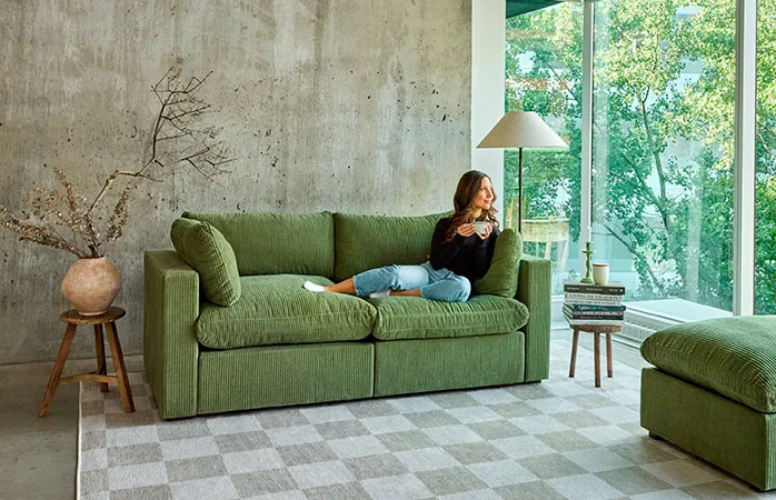Affordable green sofa by Cozey