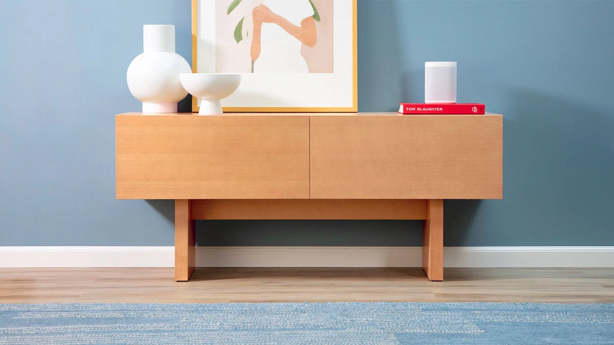Wooden minimalist credenza with white decor and an abstract painting