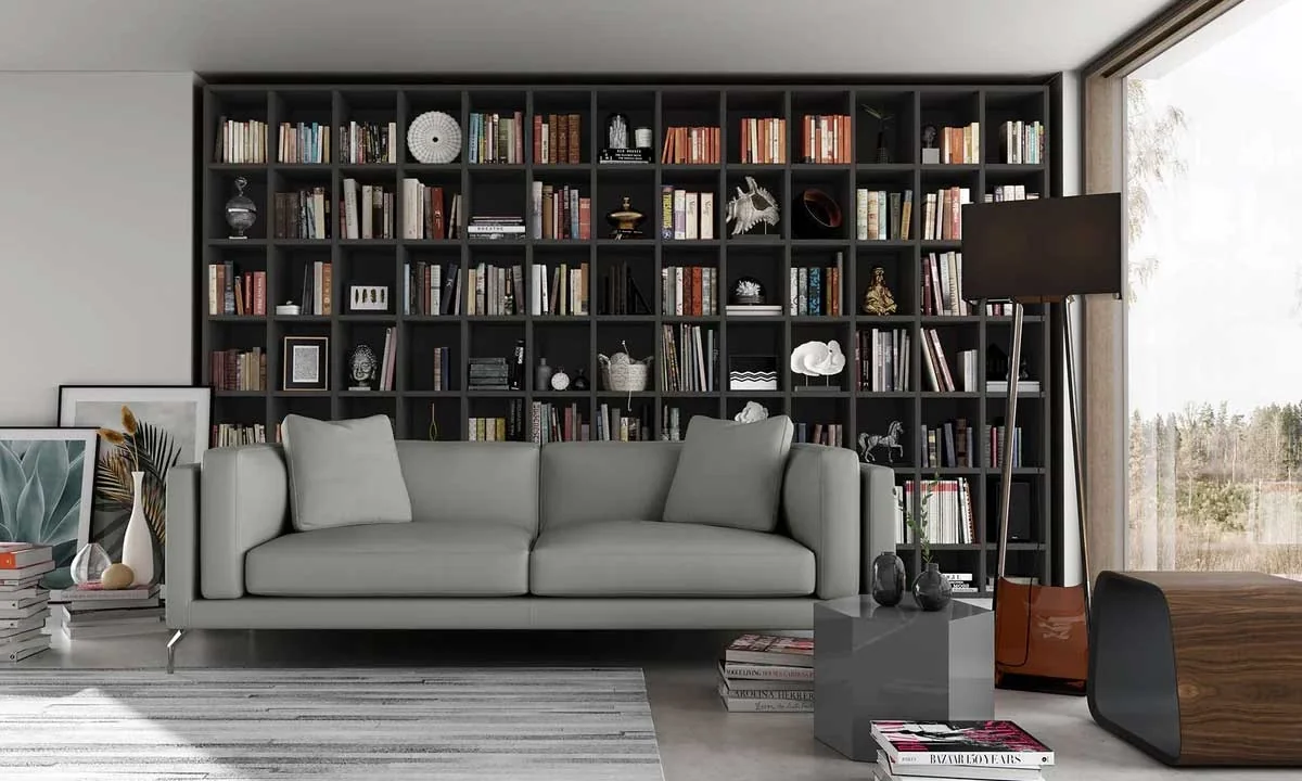 A living room with a grey sofa and a well-stocked bookshelves creating an atmosphere for reading