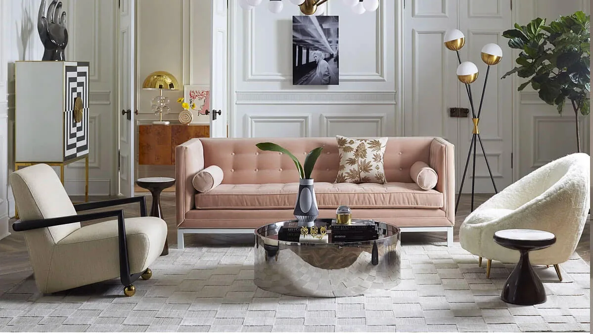 Light oeach velvet sofa in a living room with a beige accent chair, a silver coffee table and a rug