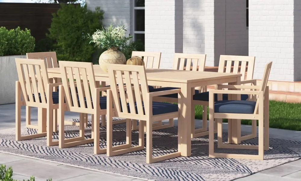Wooden Rectangular Outdoor Dining Set on a rug in a patio surrounded by plants in a sunny day