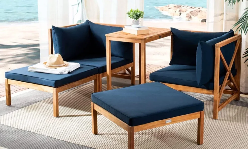 Outdoor furniture 5 seat set made of wood with blue cushions for comfort.