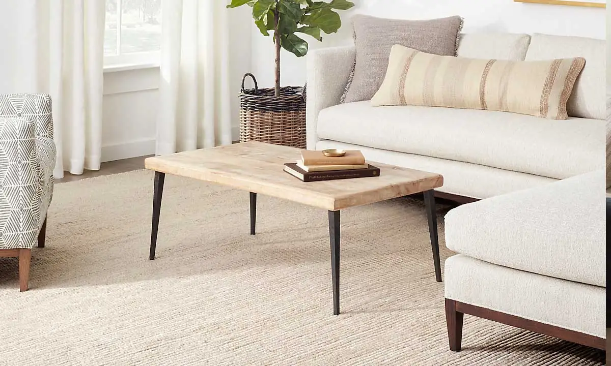 White Latte Handwoven Rug in a bright living room with a wooden coffee table