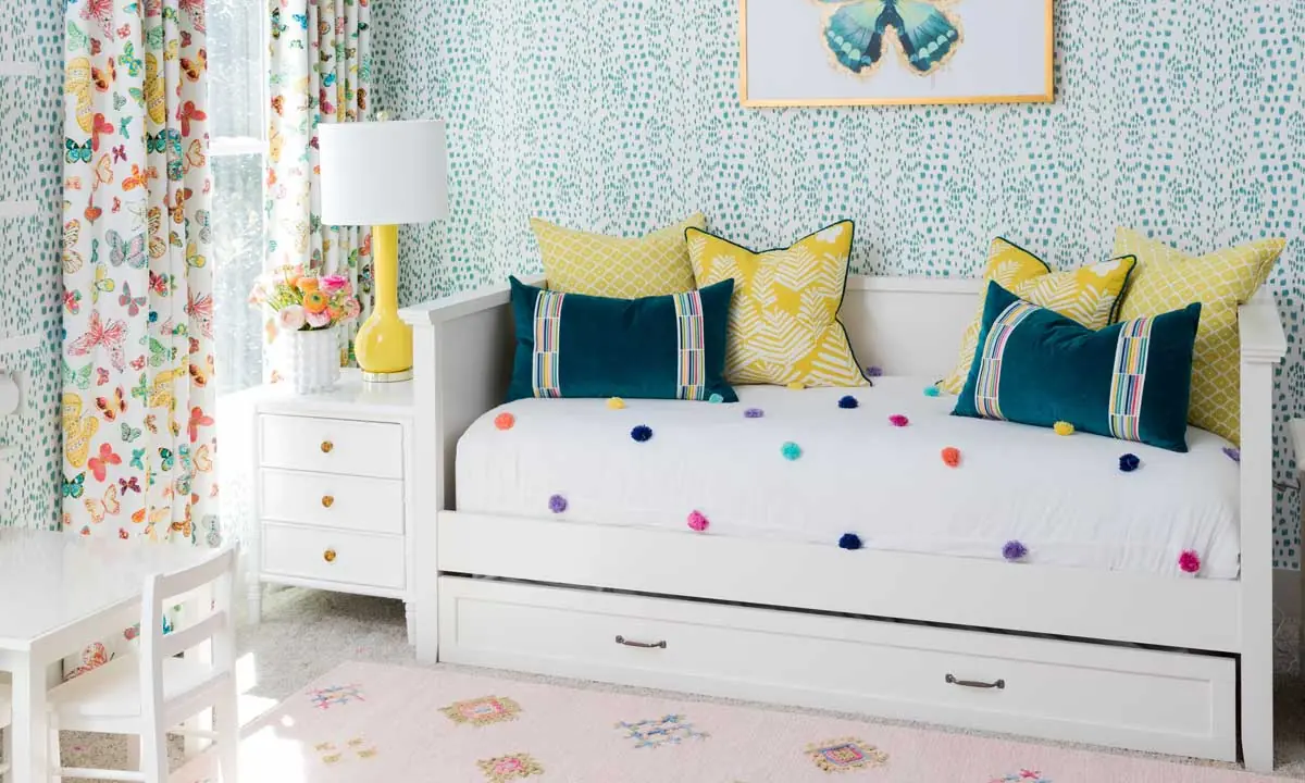 White daybed with with built-in storage in a bright and colorful room