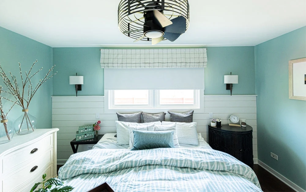 Light blue bedroom with mismatched nightstands