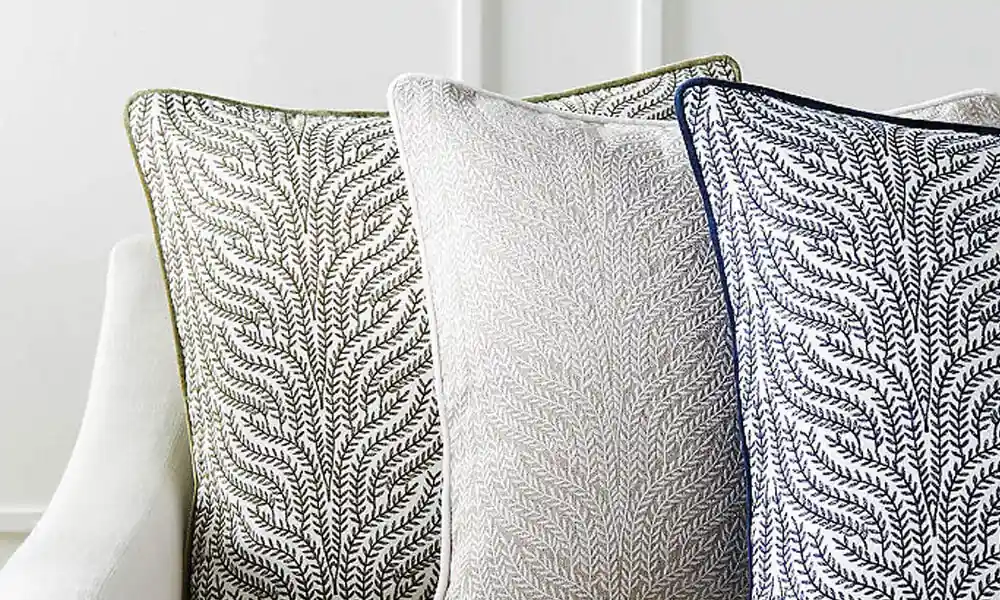 Three decorative pillows with unique and patterned designs 