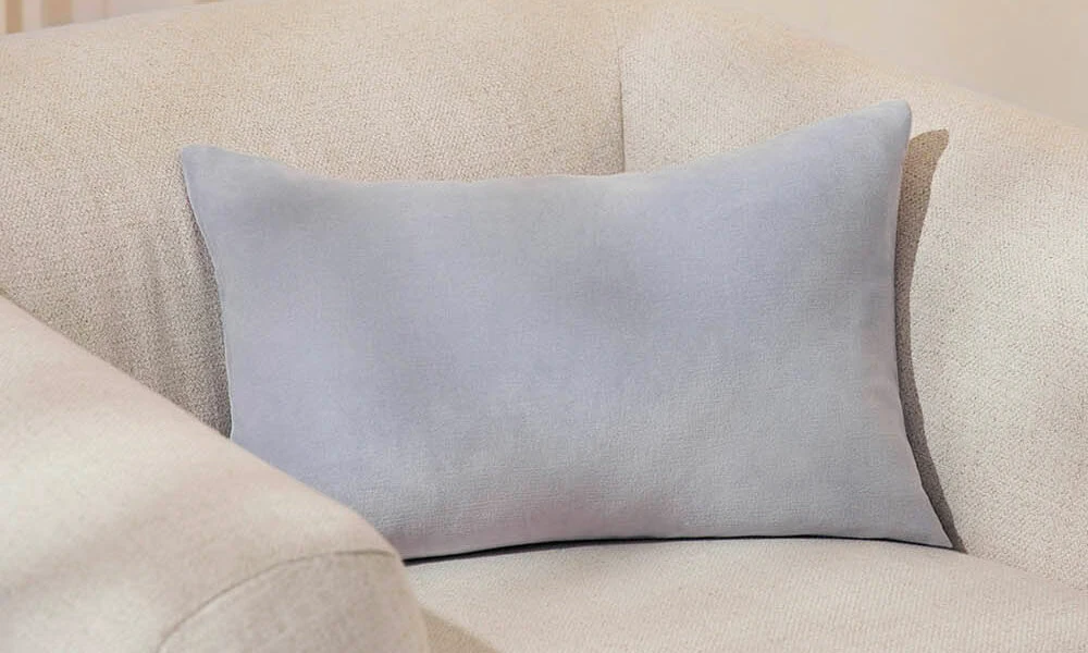 grey Velvet Pillow in a couch