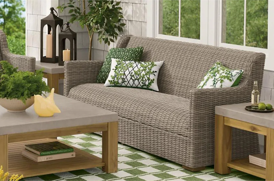 Wicker outdoor set without cushions and blue throw pillows