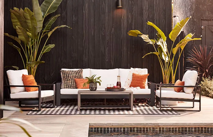 Black aluminum framed outdoor sofa set with white cushions