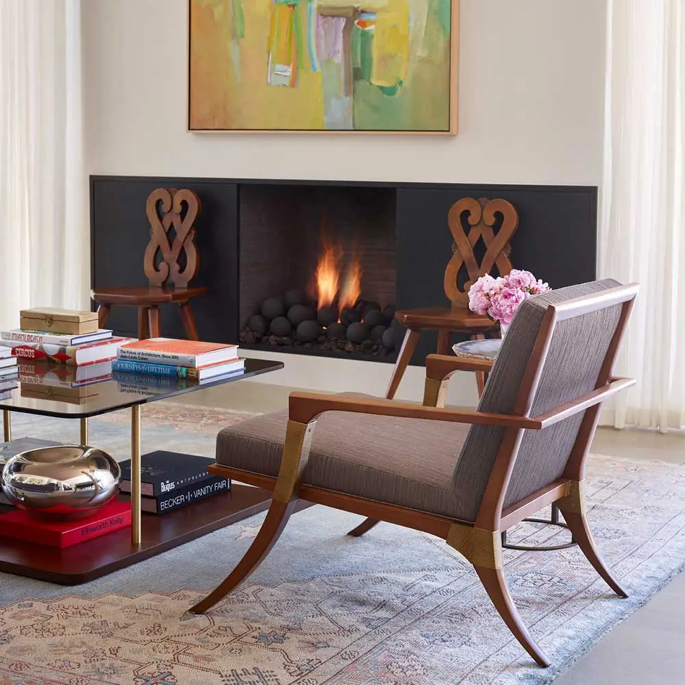 Mid century living room with a wooden accent chair with grey seat anc back cushions