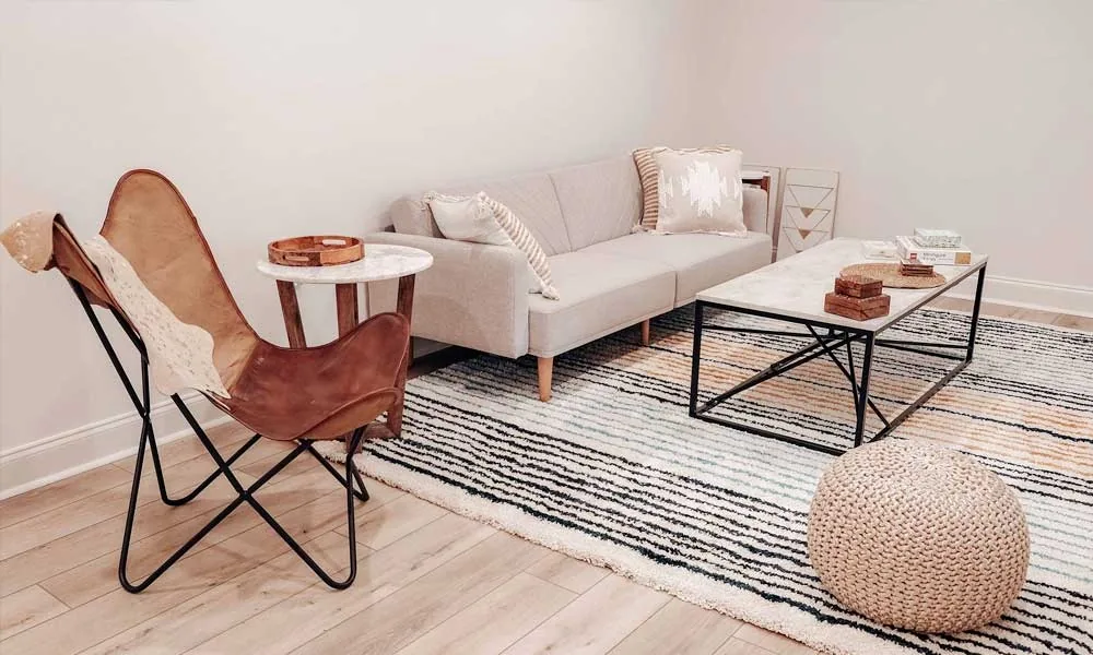 A living room setup with a couch, a chair and a table with different textures