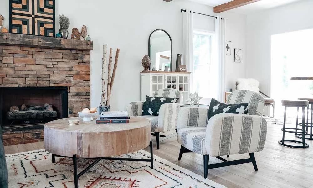 Living room featuring a fireplace, comfortable chairs, and a soft rug on the floor