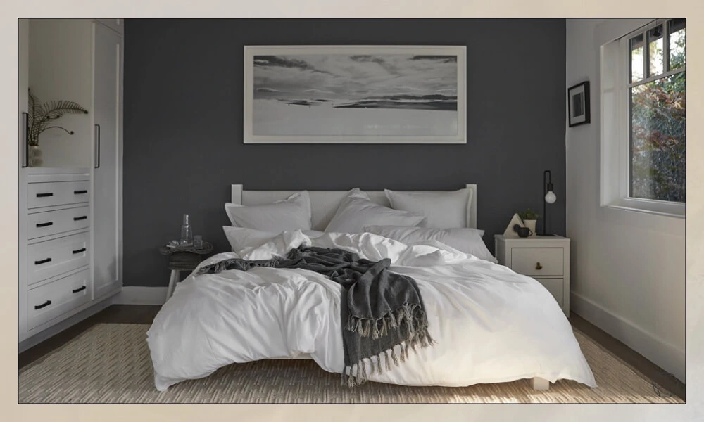 Textured Wool Rug in a bedroom with a bed covered with a white duvet and cozy pillows