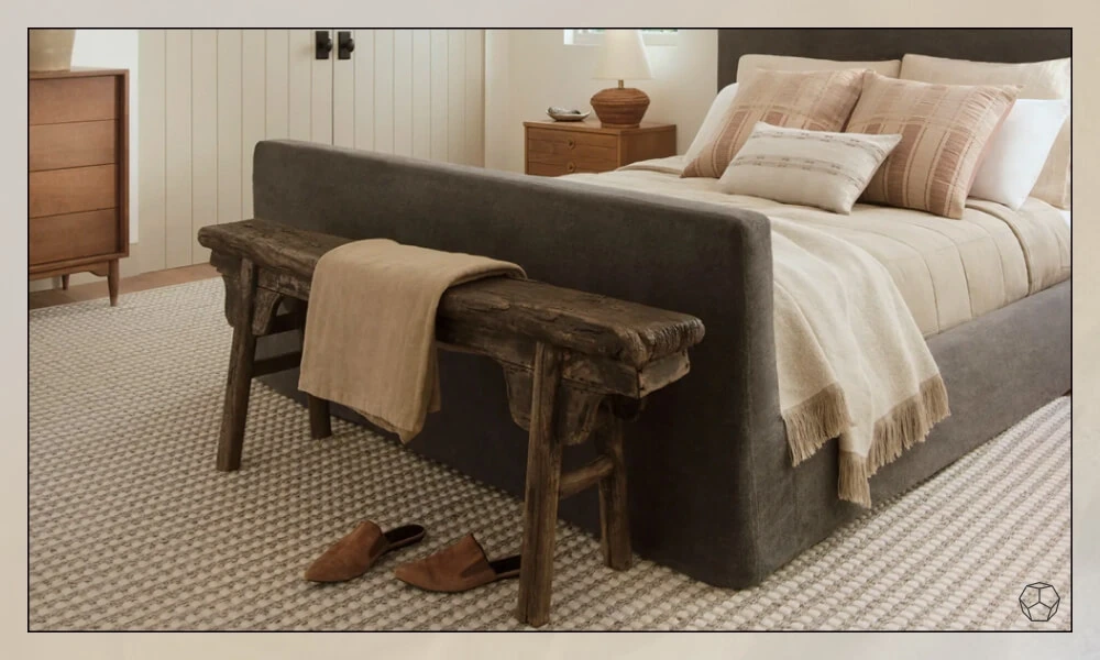 Sophisticated braided rug in a elegant bedroom with a grey bedframe with white and beige pillows