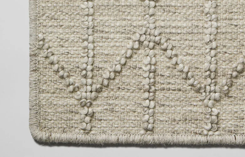 Light grey rug with trellis patterns