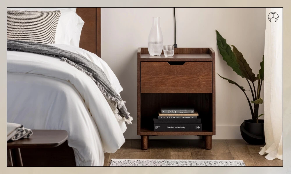 Wooden Nightstand with one drawer in one side of a wooden bedframe with grey bedding