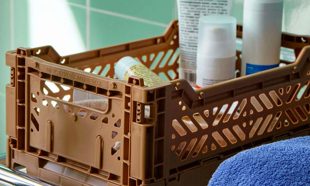 Brown storage Crate with bathroom goods in it