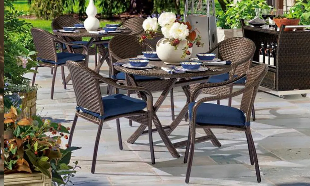 Dark brown Square Back Chairs with blue seat cushions and a table 